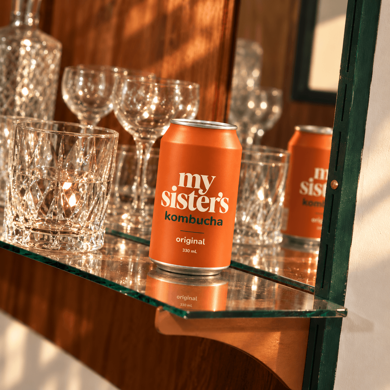 Dry Original kombucha can among glassware on a shelf